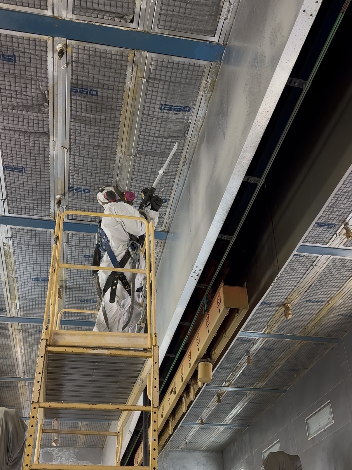 Dry ice blasting a paint booth interior