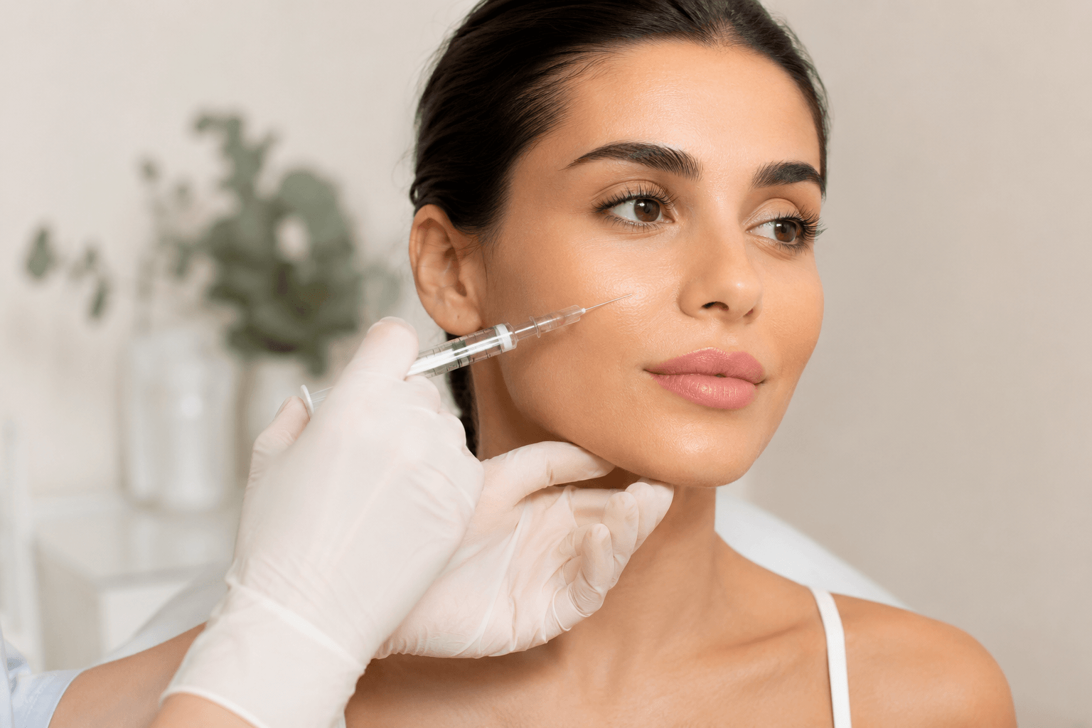 Patient receiving dermal fillers in Tampa Florida to improve facial volume, smooth smile lines, and enhance lips and cheeks naturally