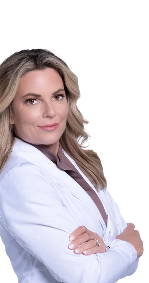 Confident woman with blonde hair wearing a white coat and brown shirt, arms crossed.