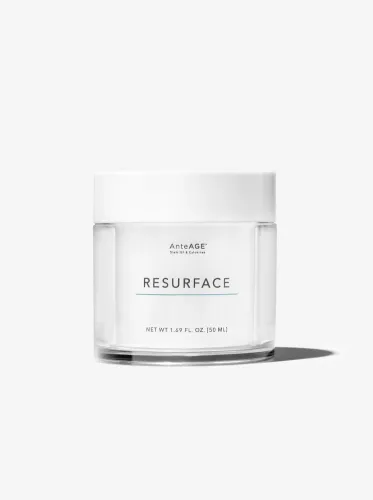 Clear glass jar of AnteAGE Resurface cream with a white lid on a white background.