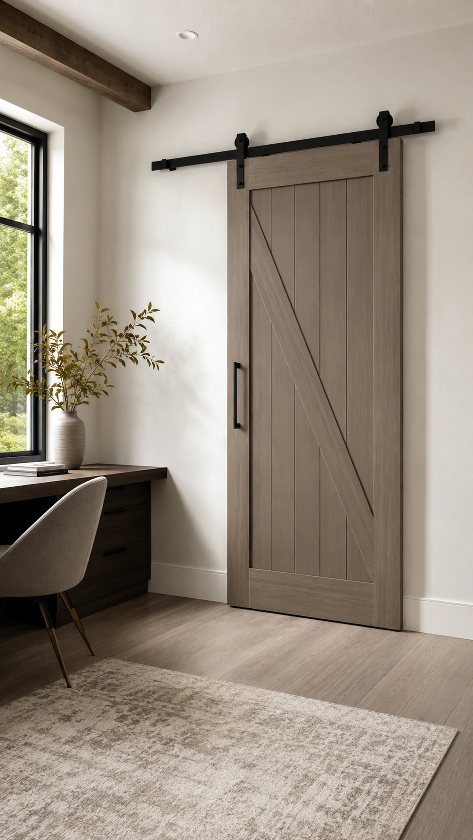 Grey-stained barn door with a Z brace, closed beside a desk