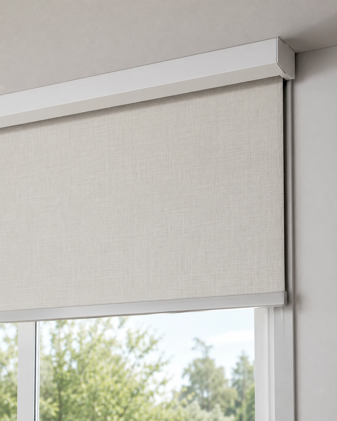 Close view of a cassette roller shade headbox above a window