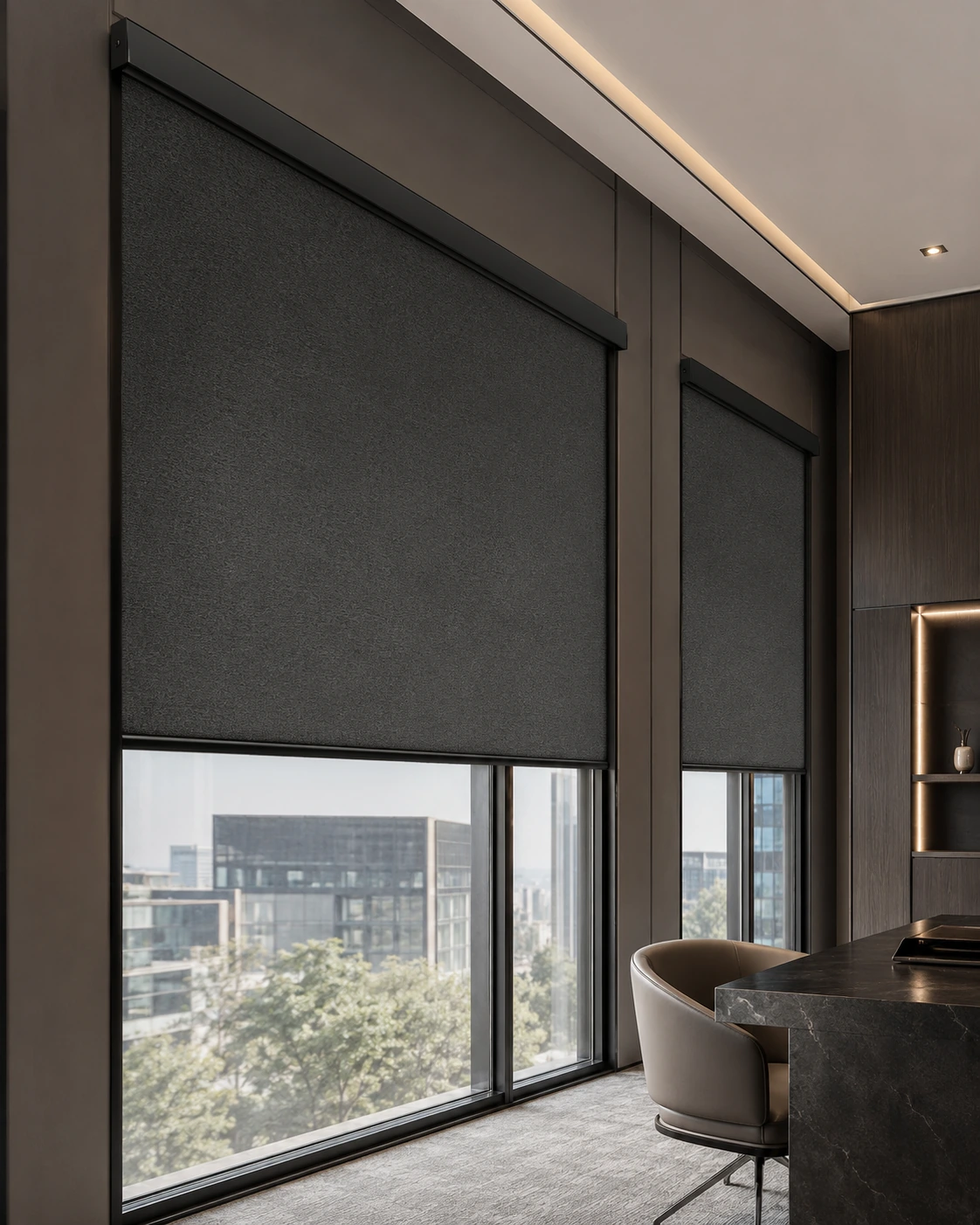Dark cassette roller shades across the corner windows of a modern office