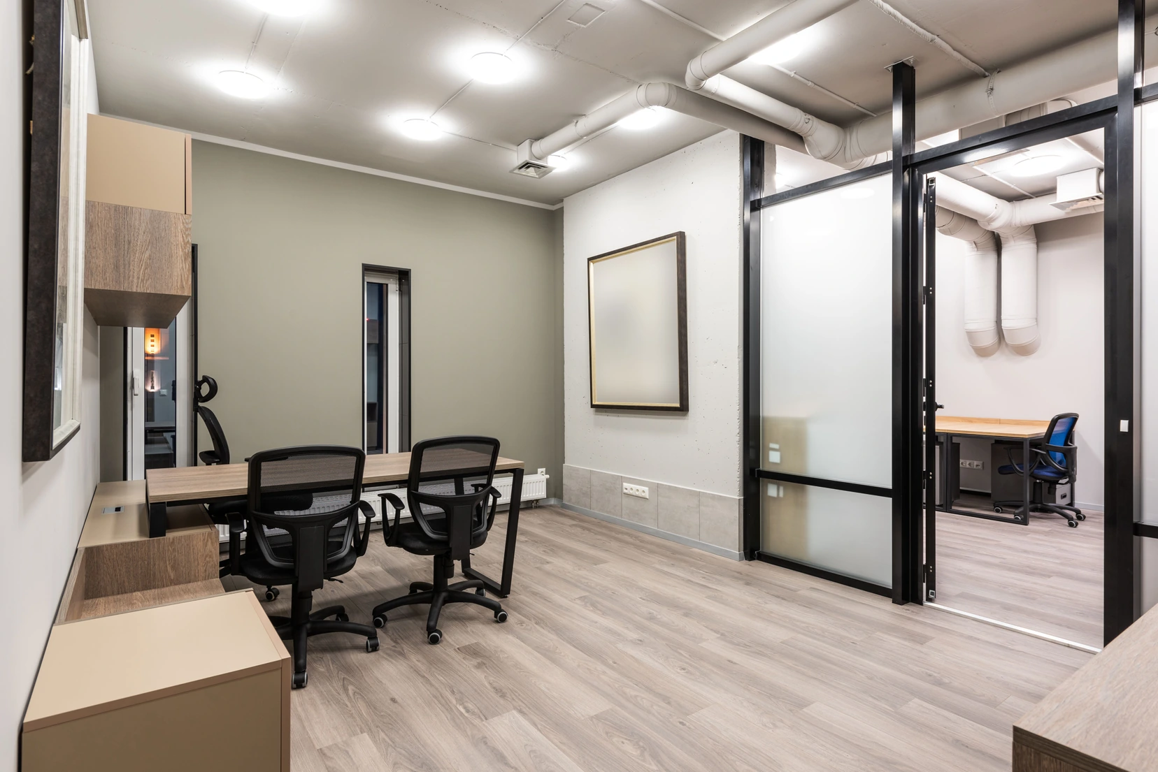 Grey wood-look vinyl flooring in an office with glass partitions