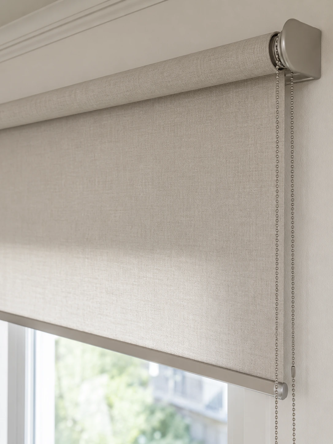 Close view of a manual roller shade with its chain control
