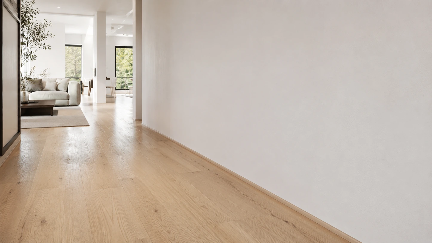 Quarter round trim running along a wall above wood flooring
