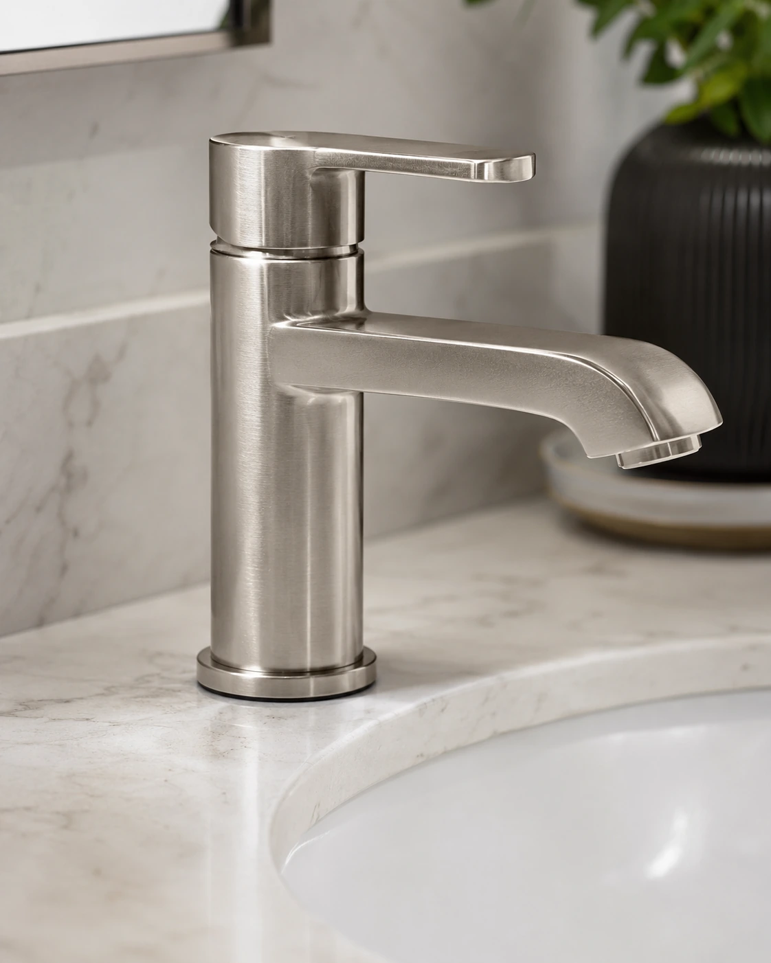 Brushed nickel single handle bathroom faucet on a marble basin