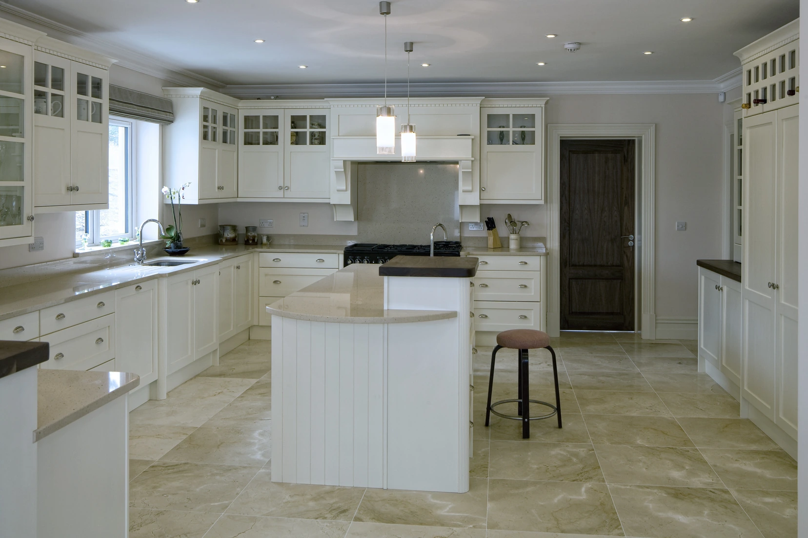 Stone-look vinyl flooring in a white kitchen with an island