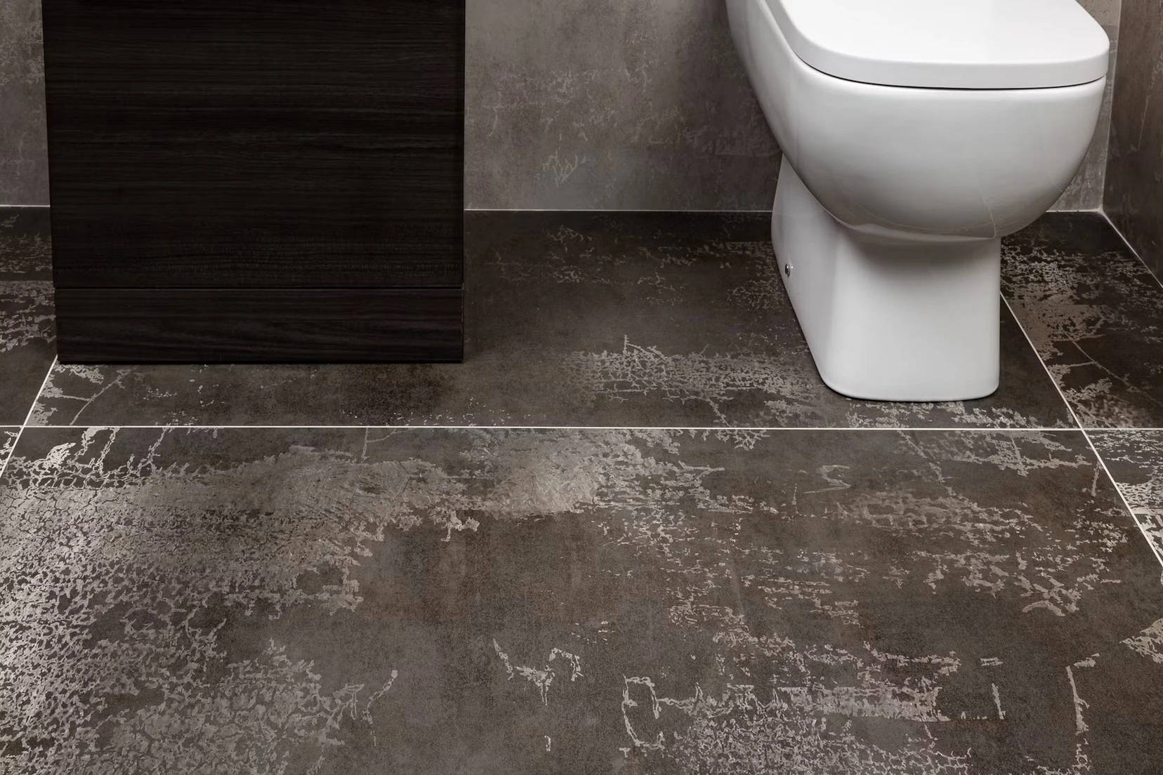 Stone-look vinyl flooring in a bathroom beside a toilet
