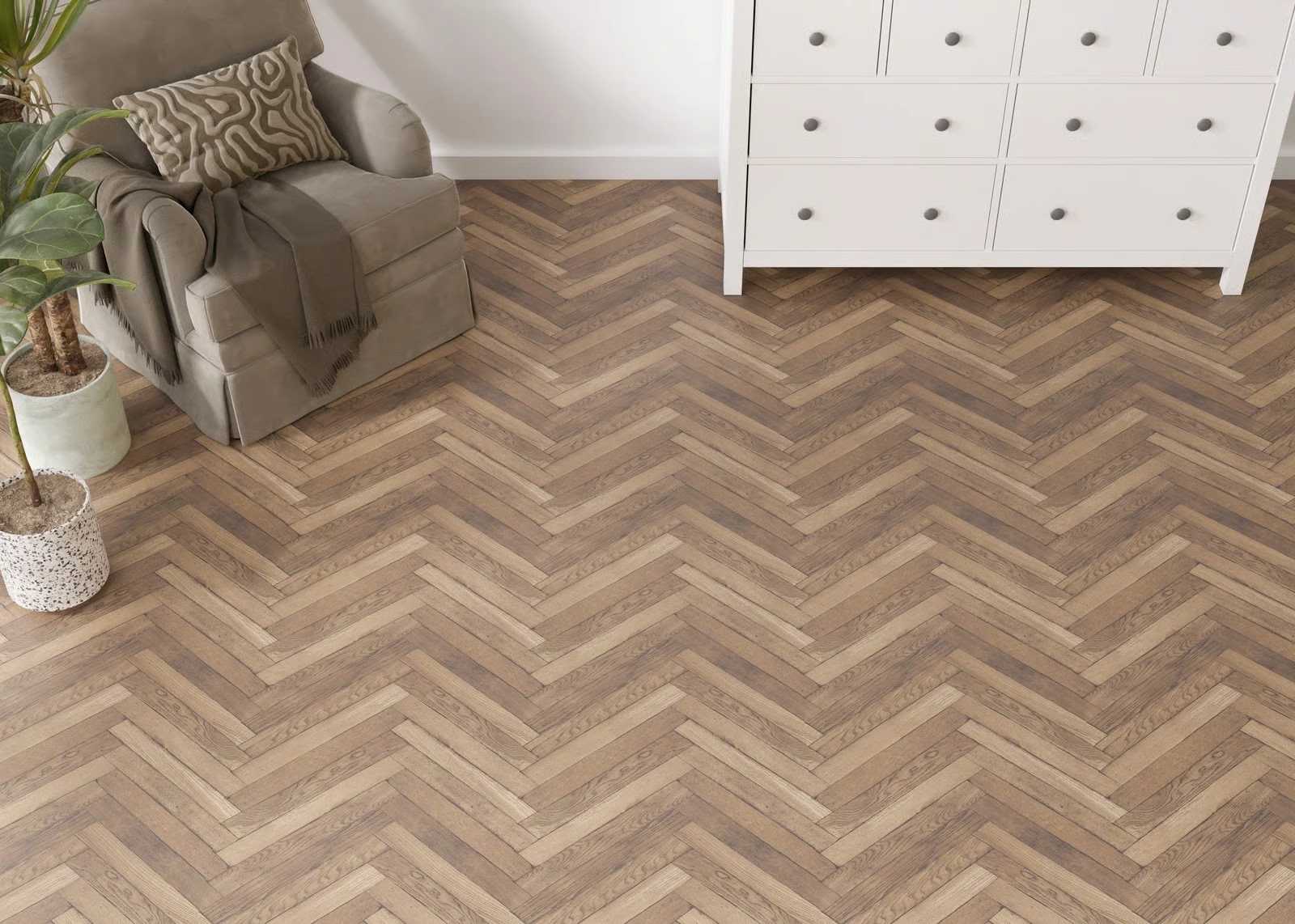 Herringbone wood look vinyl flooring in a room with a cream dresser and an armchair