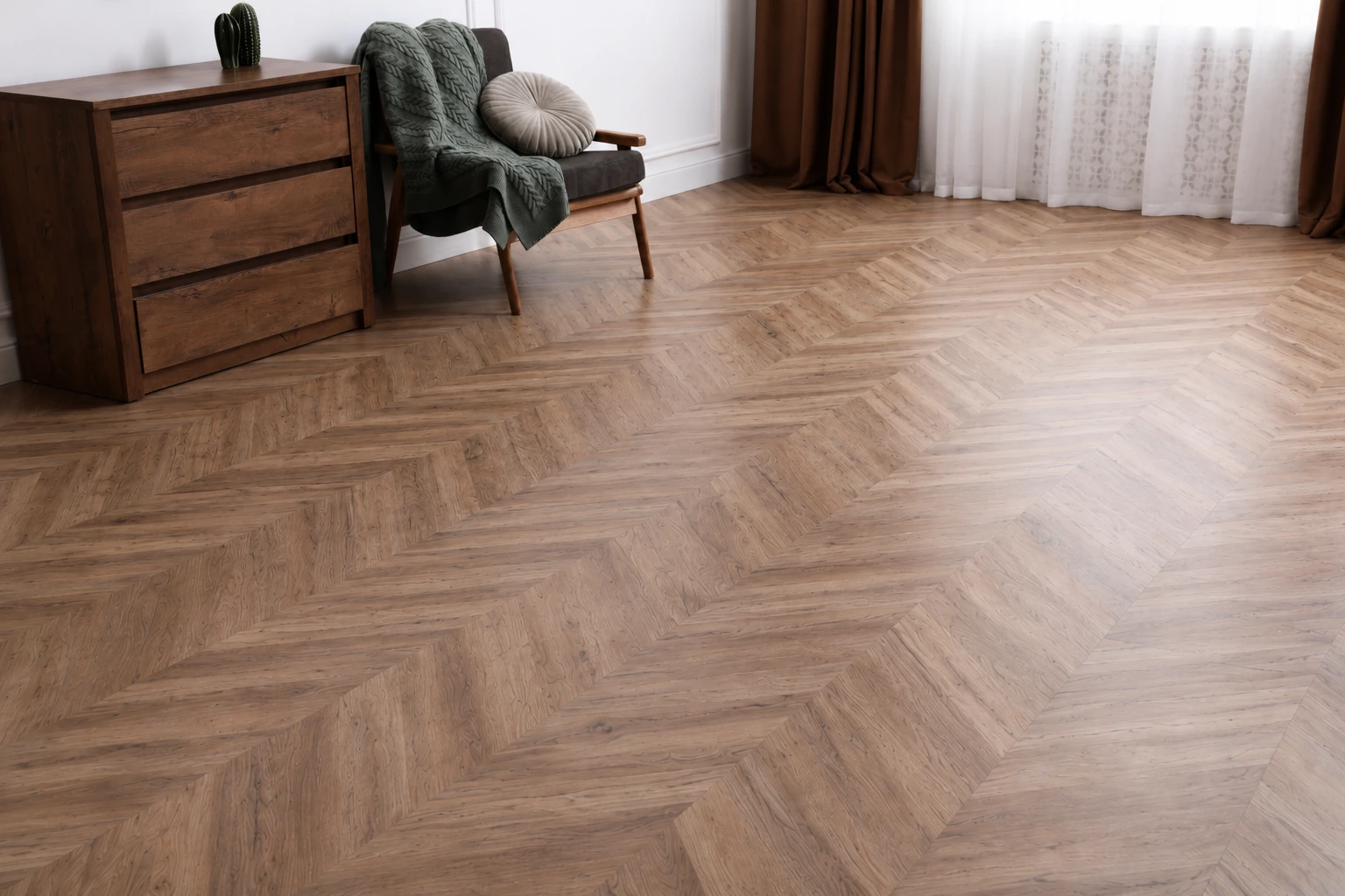 Herringbone wood look vinyl flooring in a living room with a dark wood dresser