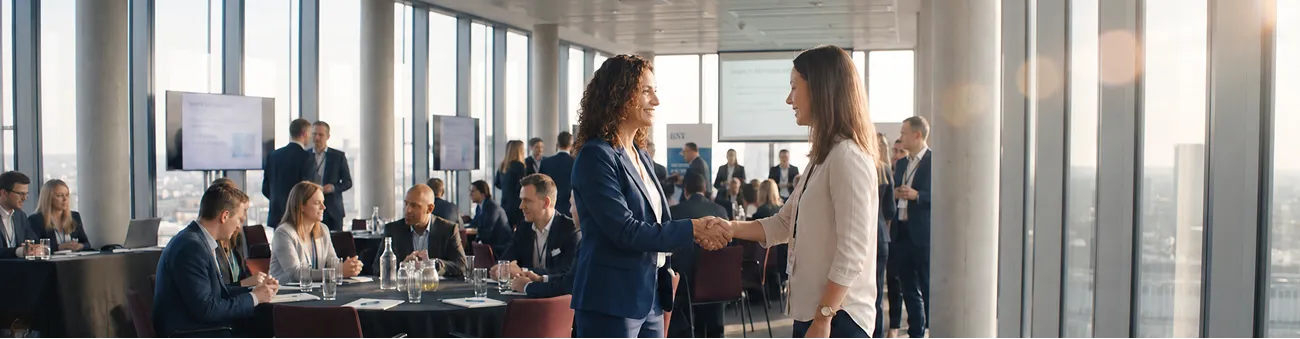 Two professionals shaking hands inside an aircraft cabin