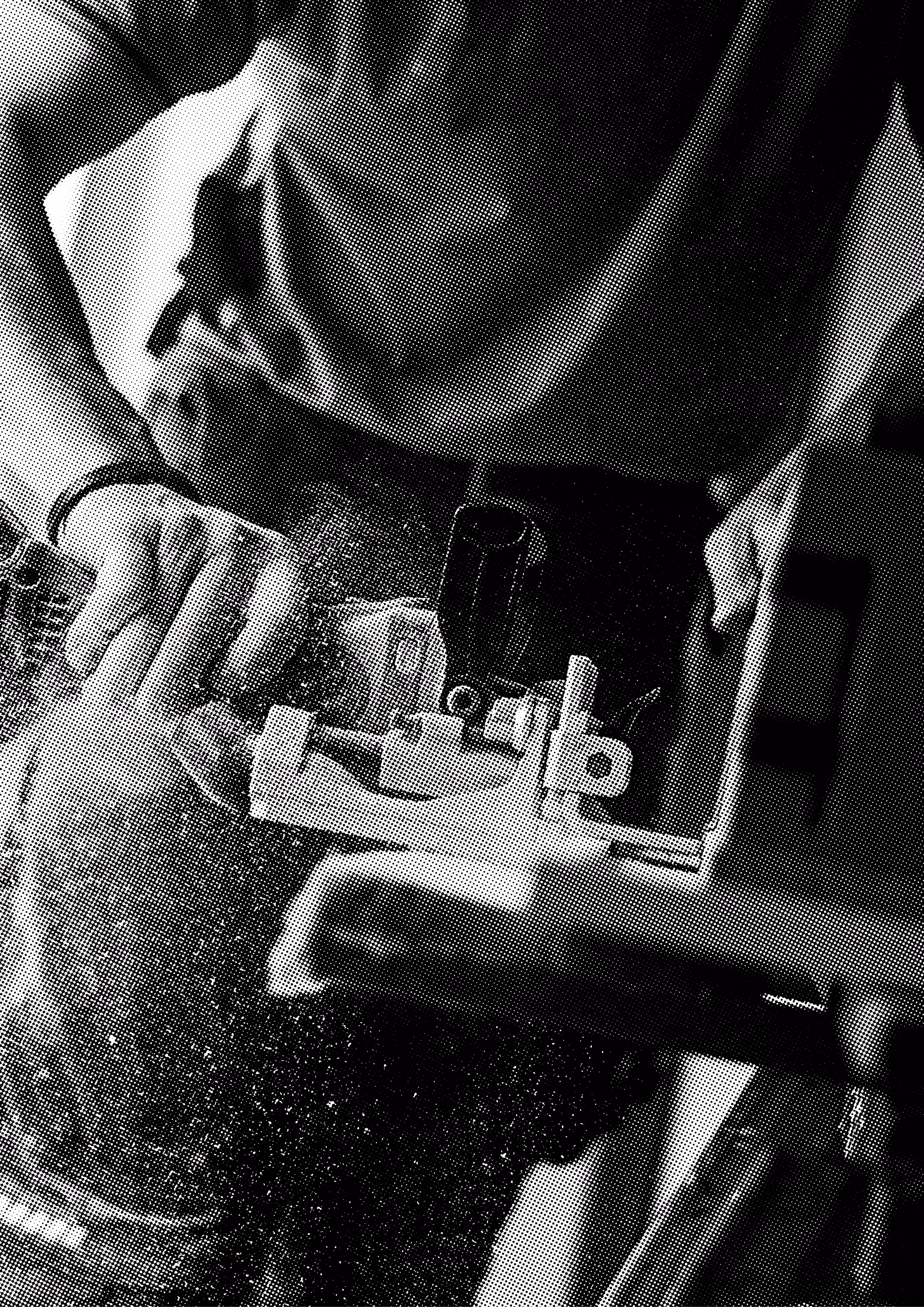 Person using a handheld power tool to cut or sand a piece of wood with dust flying.