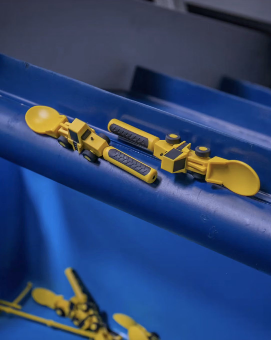 Four-cavity overmolding tool with clear plastic tray components on the shop floor
