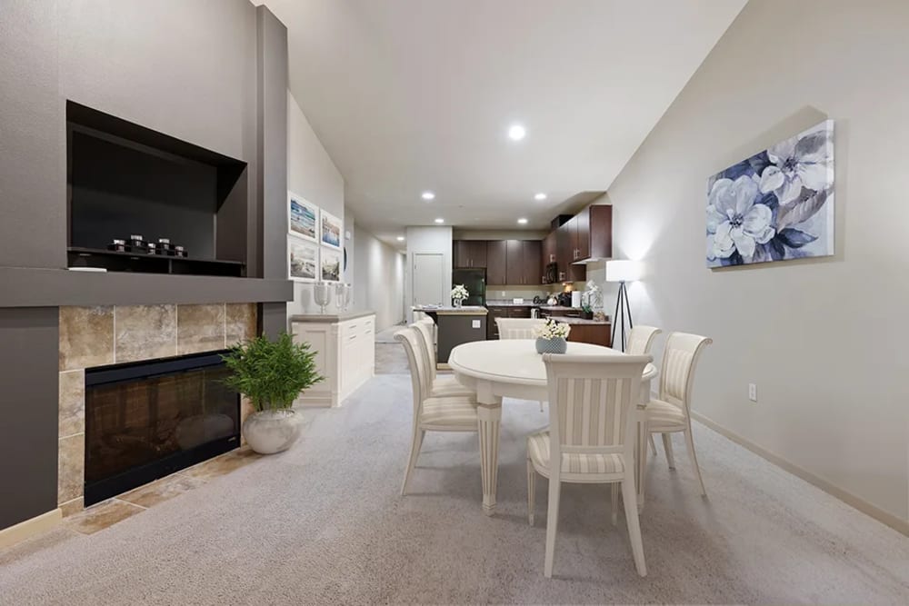 Dining room looking into kitchen with fire place