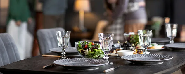 Elegant restaurant table set with wine glasses and a fresh salad