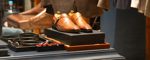 Pair of brown leather dress shoes displayed in a boutique