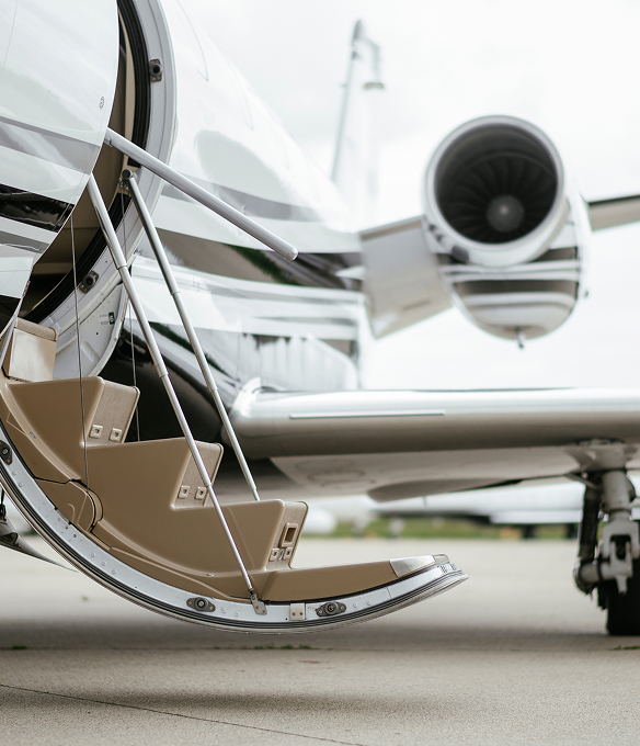Private jet with boarding stairs extended on the tarmac