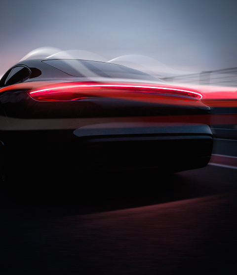 Close-up of a sports car's taillight in motion at dusk