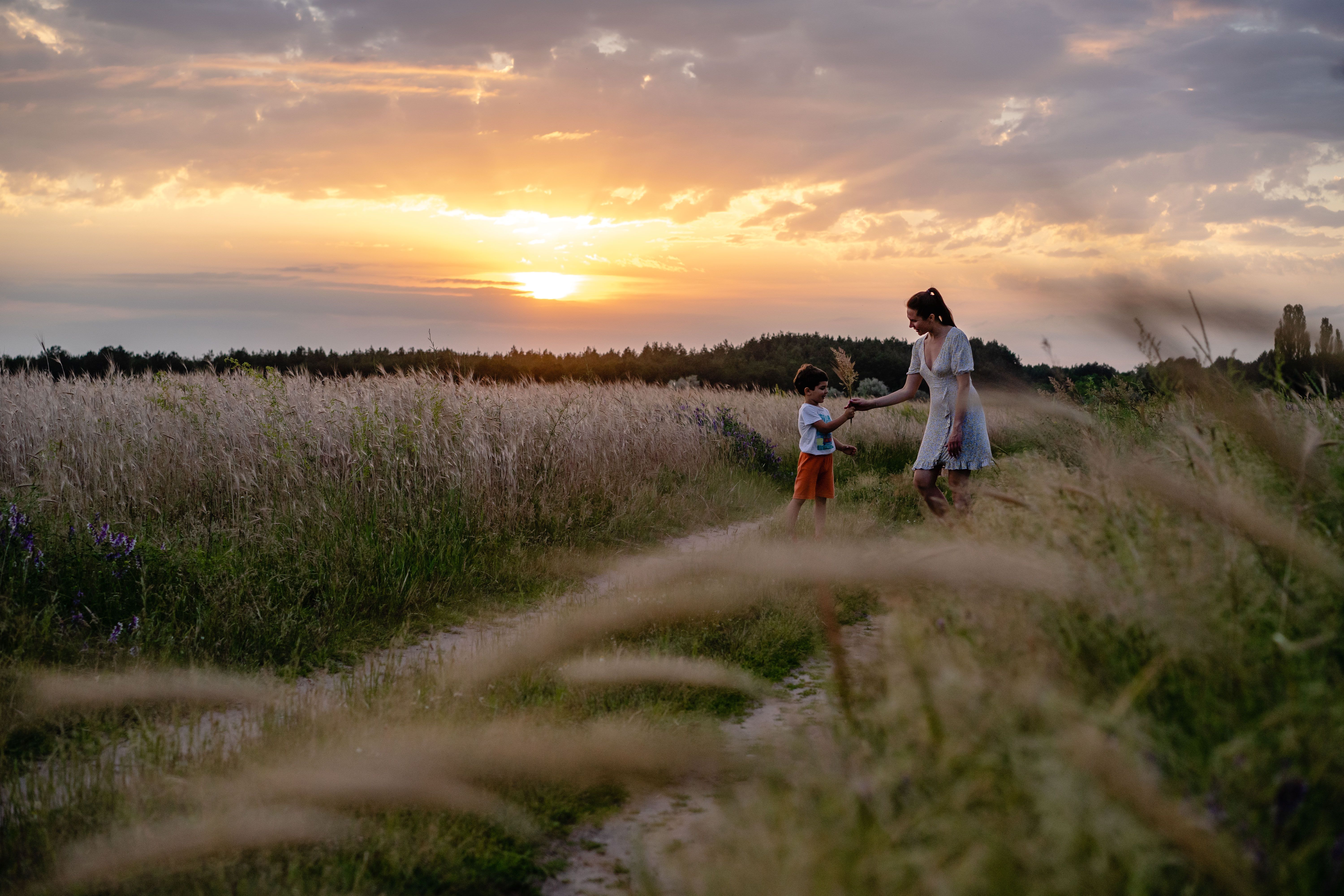 A family walking together outdoors in late afternoon light