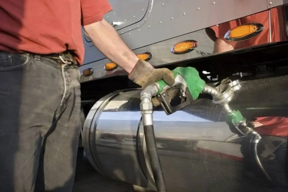 Driver filling truck tank with diesel