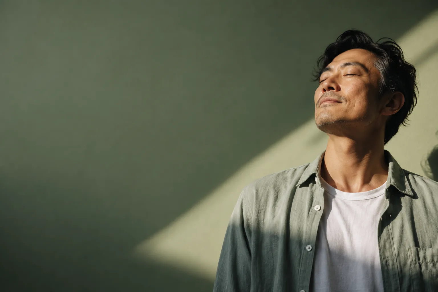 Man pausing in a beam of sunlight