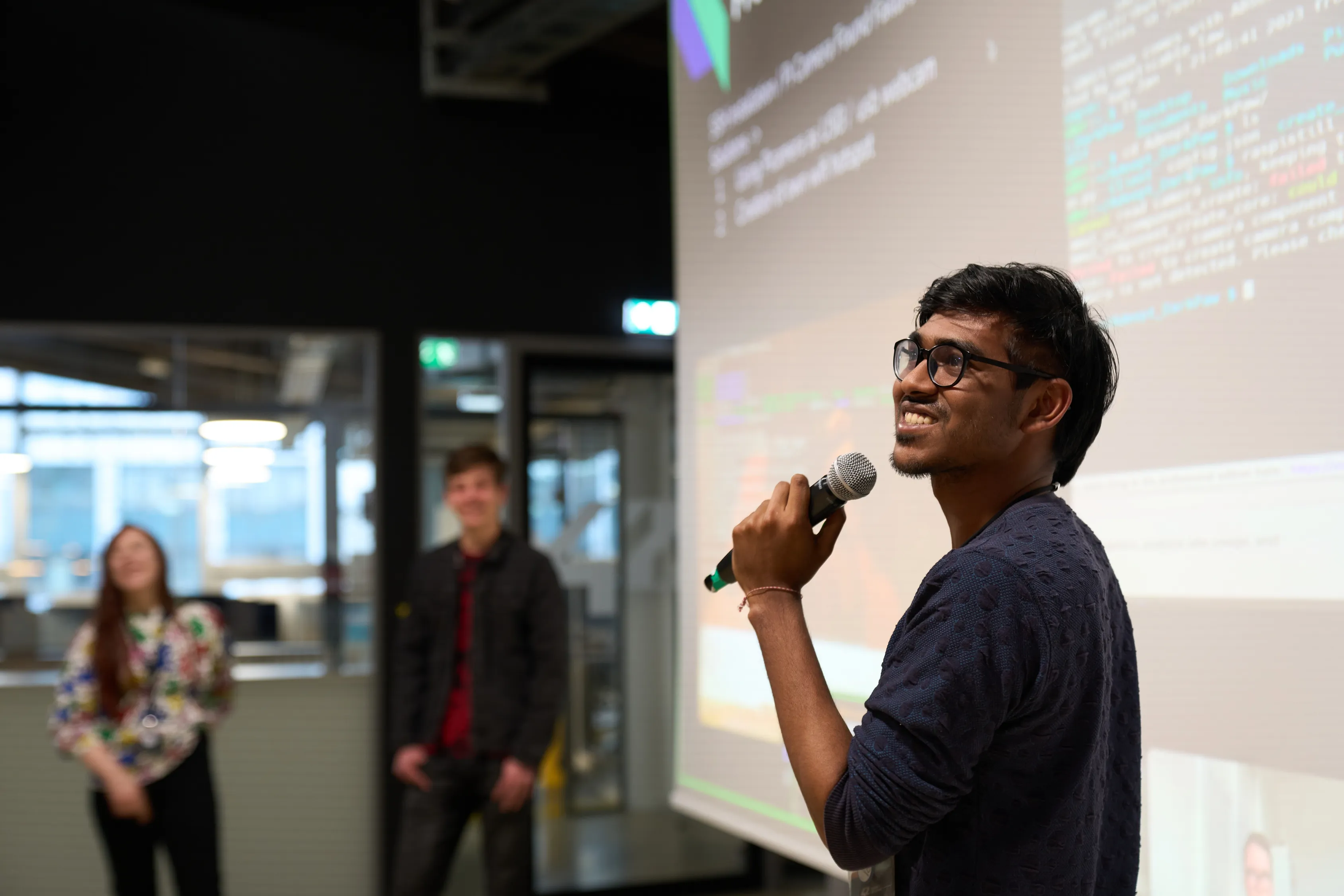 A student presenting work to peers on campus