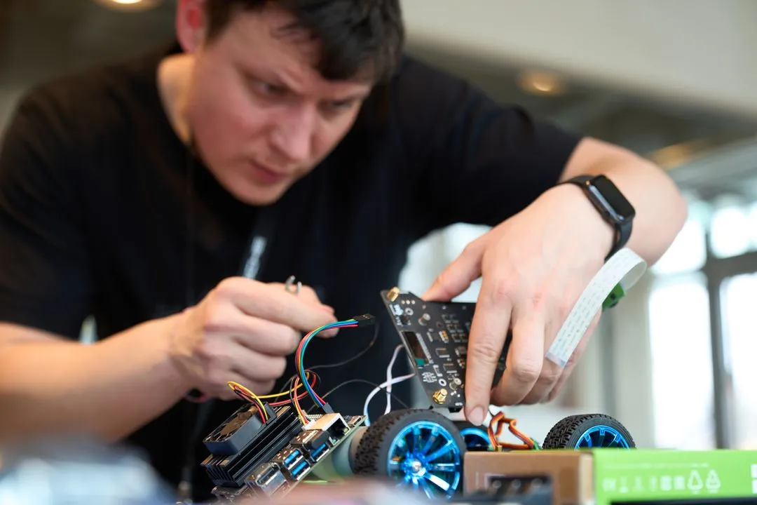 Two students assembling hardware at a bench in the 42 Wolfsburg FabLab