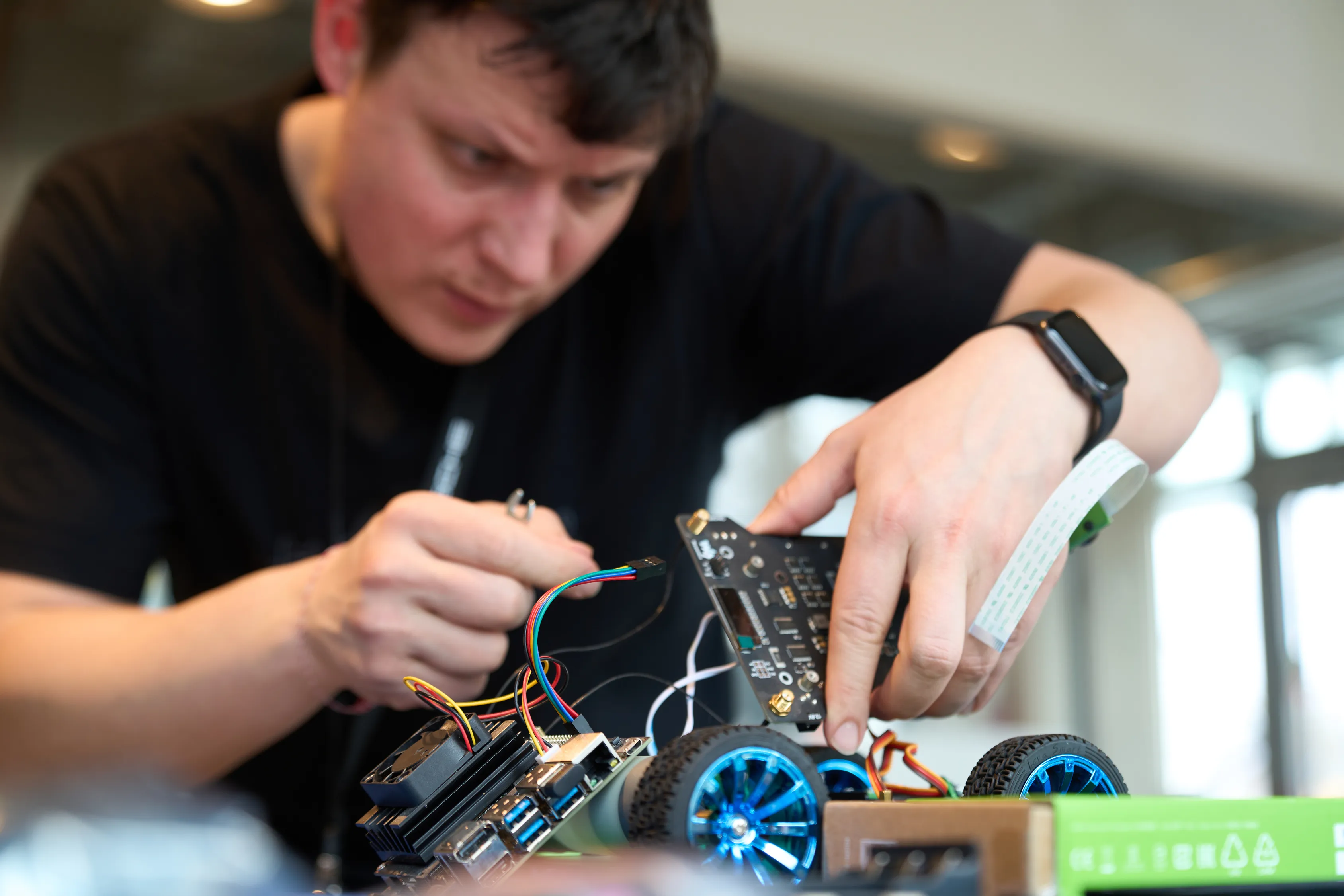 A student building robotics hardware in the FabLab