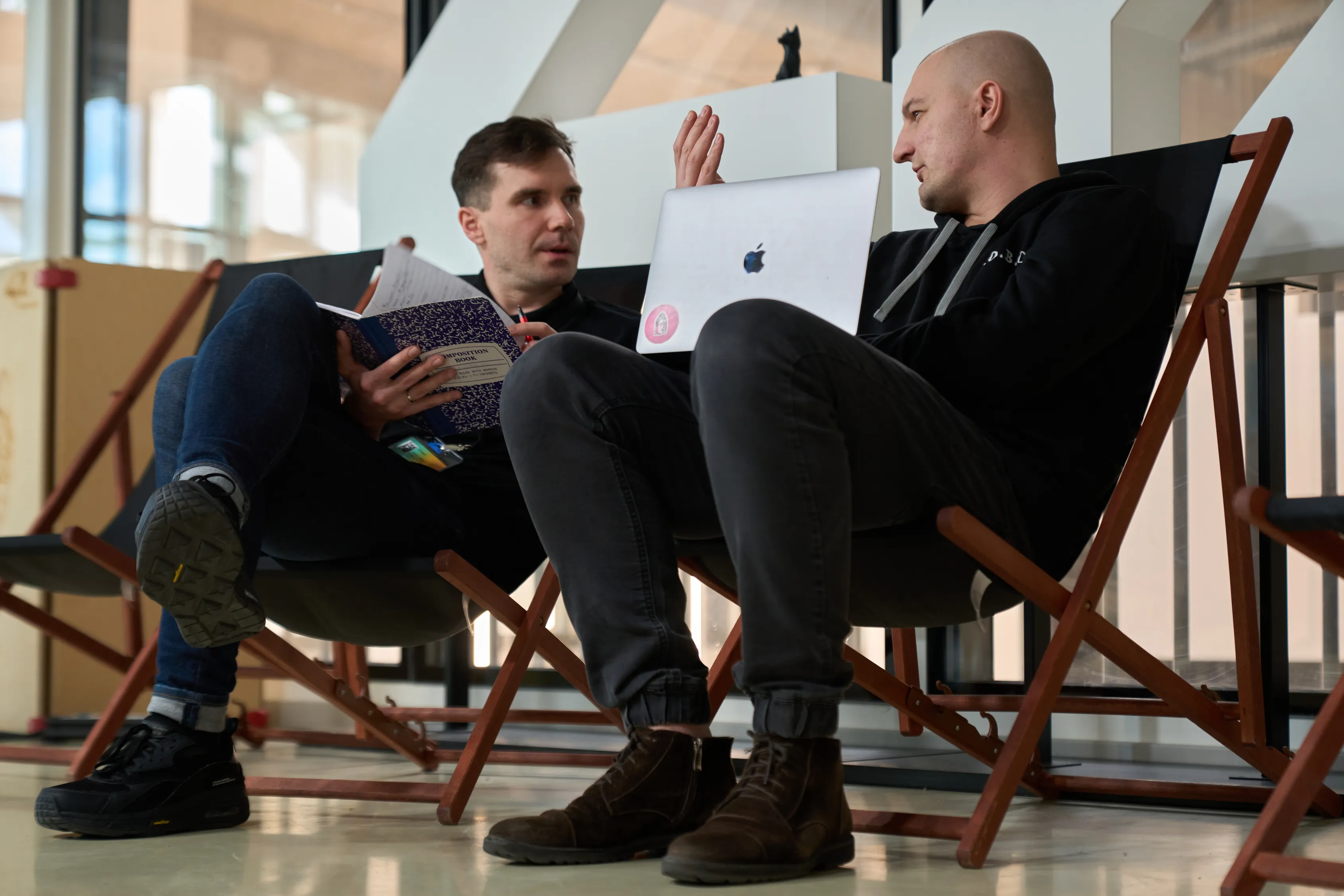 Two students talking in deck chairs
