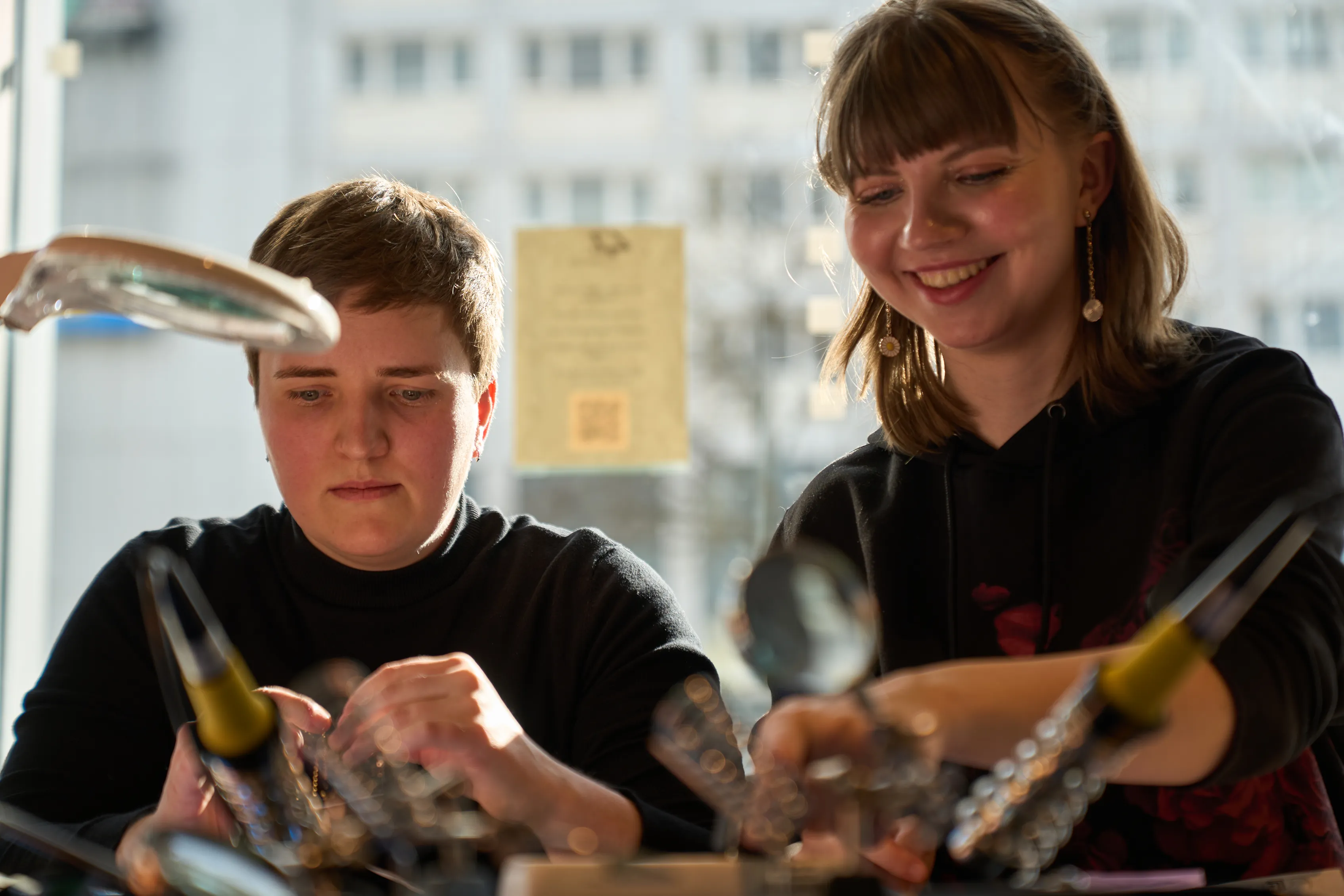 Two students working at a FabLab bench