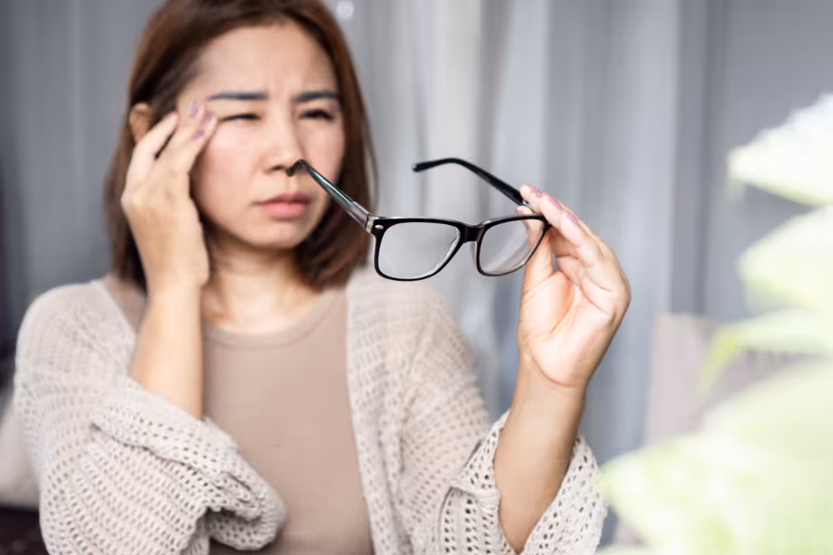 A woman with glasses who is squinting.