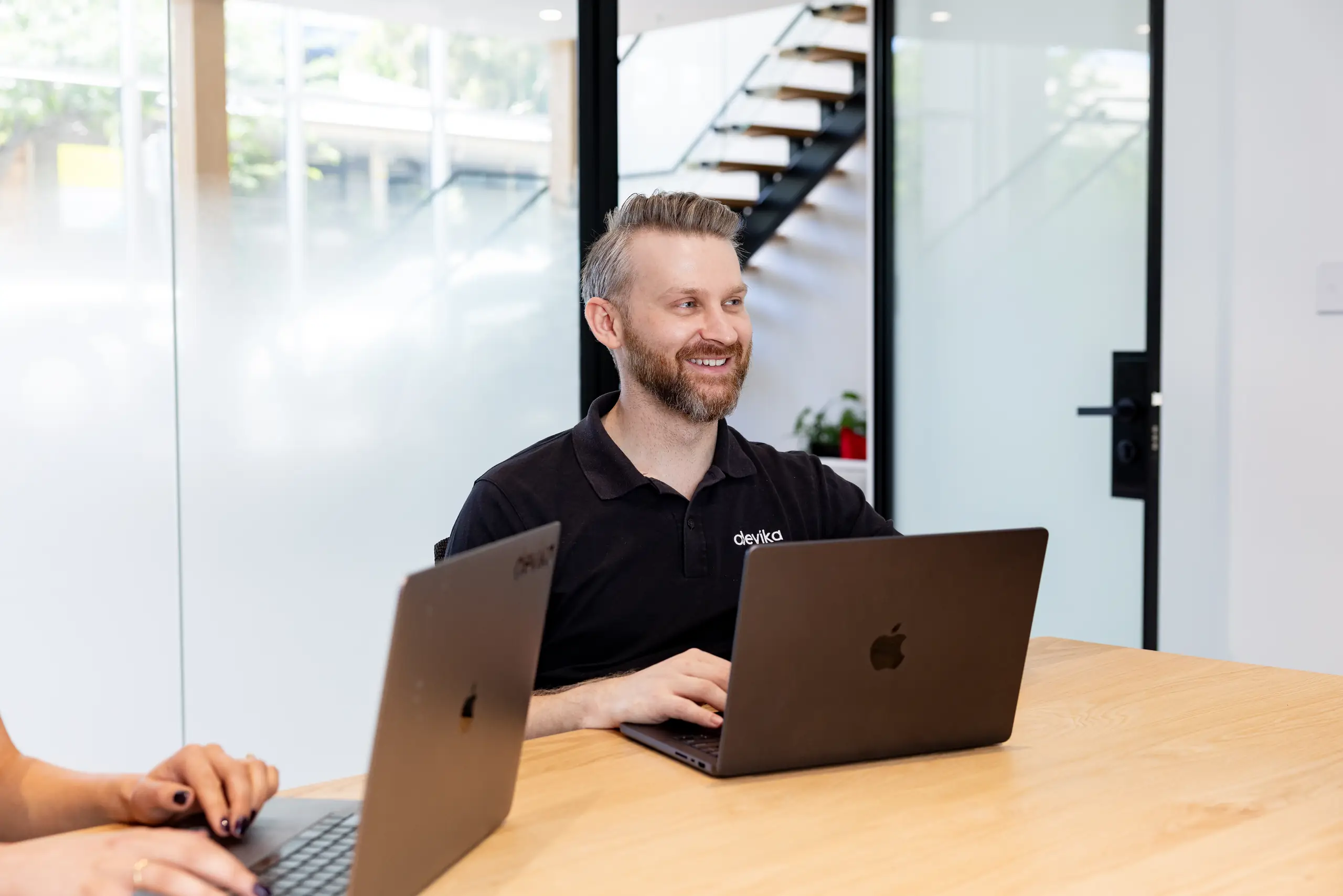 Devika team members collaborating across a meeting table