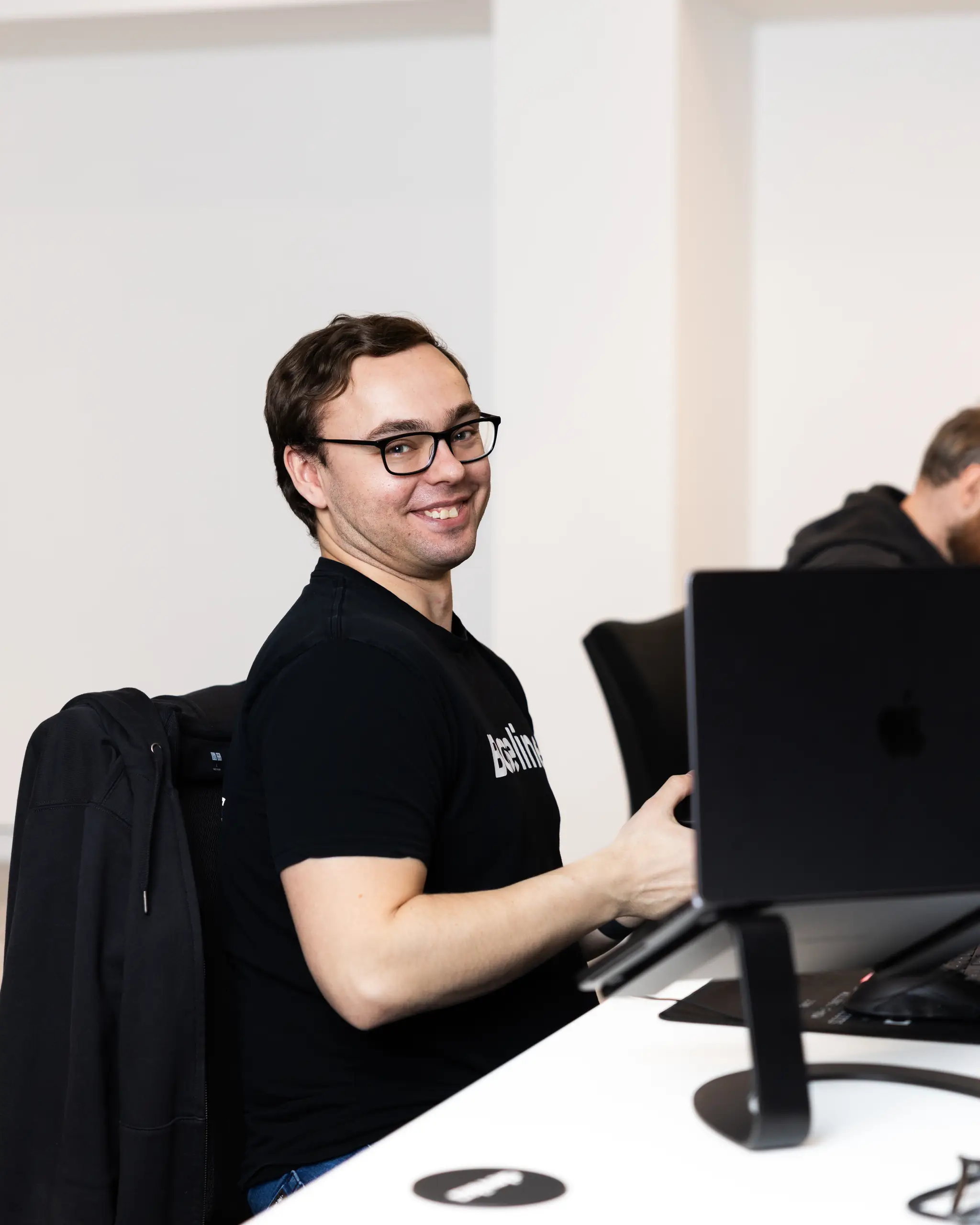 A Devika team member working at a studio desk