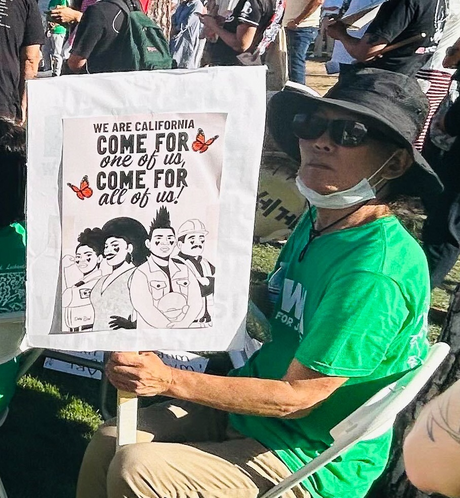 an elder holding a sign at a protest