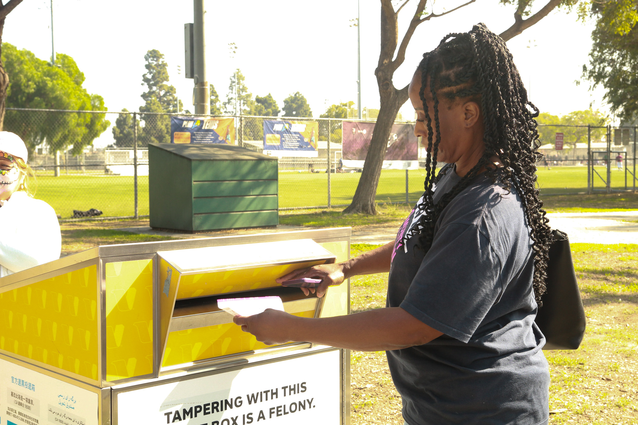 a person voting at a ballot box