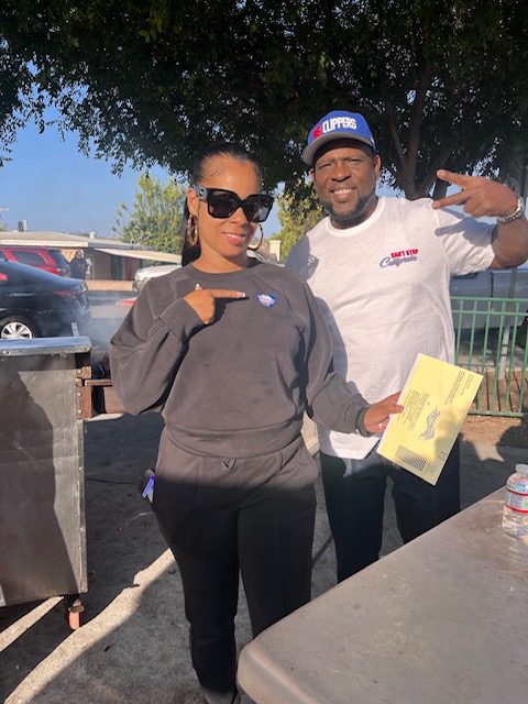 two people posing after voting