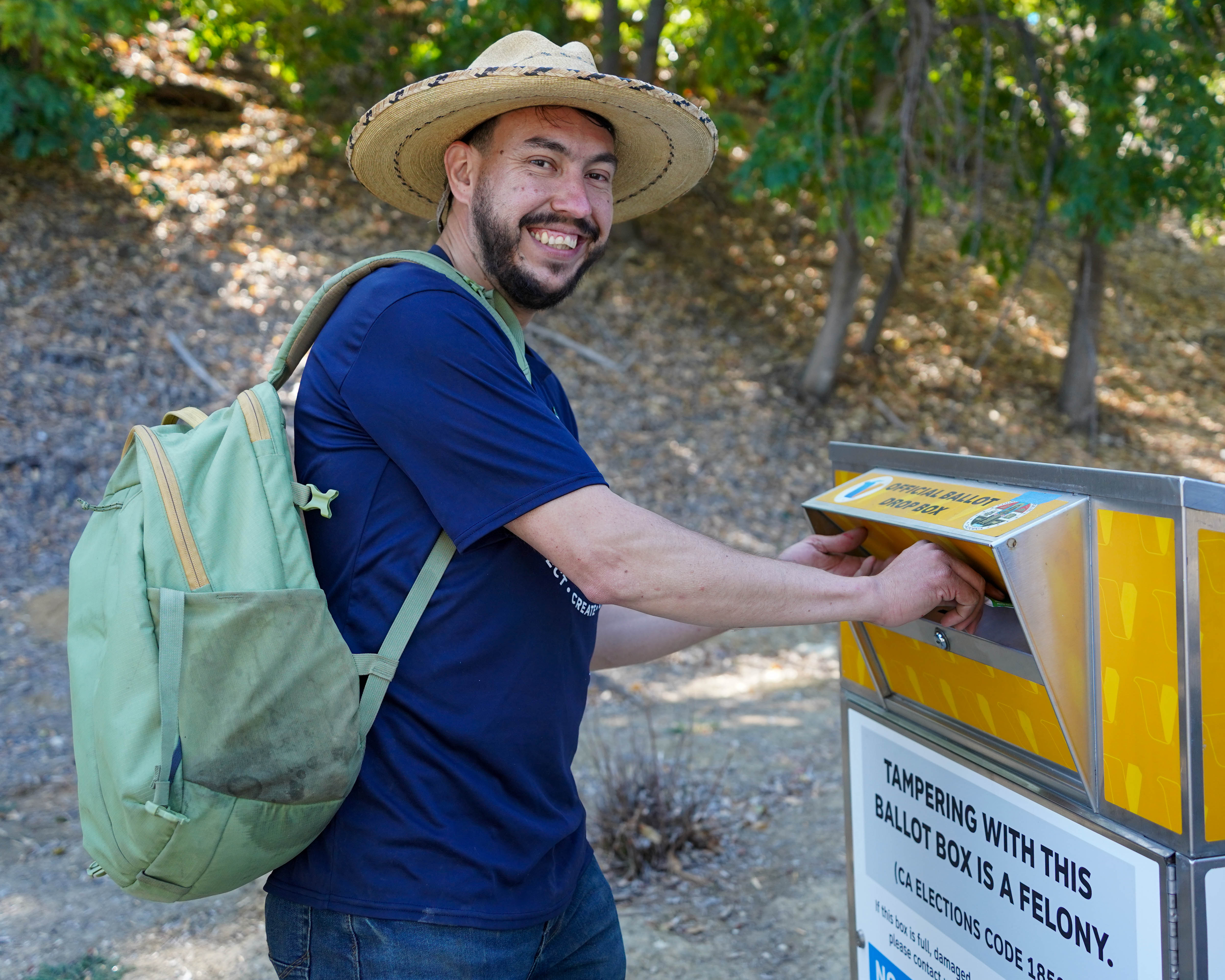 a person voting at a ballot box