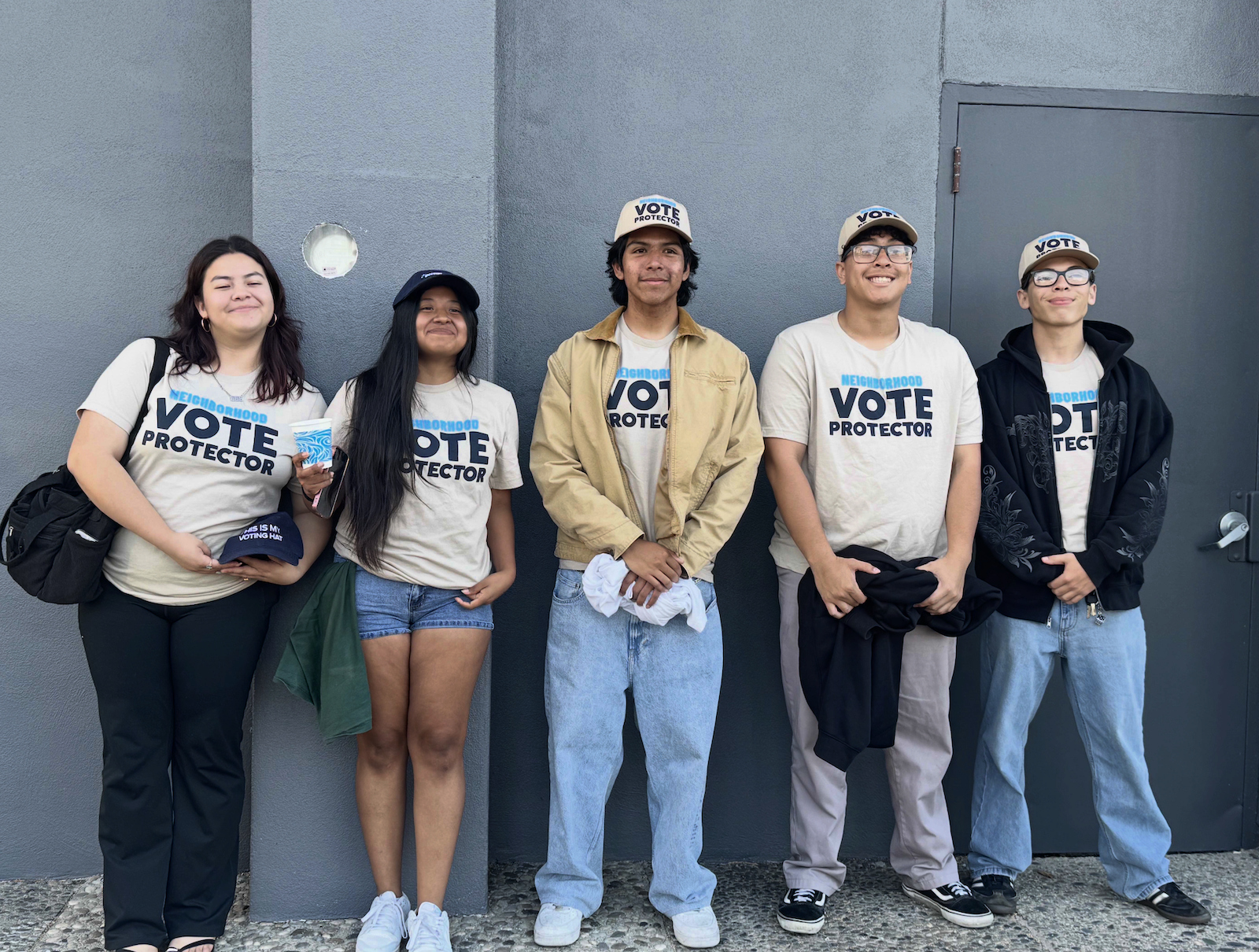 a group of young people wearing shirts that say vote protector