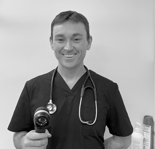 Dr Paul Bryan holding a dermatoscope at Bulimba Skin Cancer Clinic