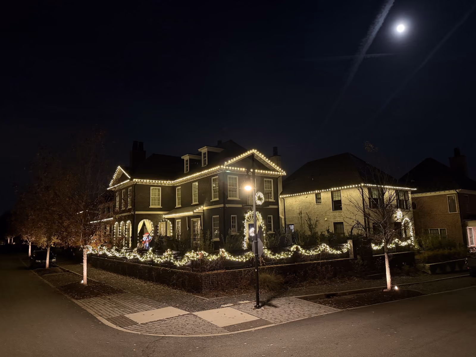 House decorated with holiday lights at night.