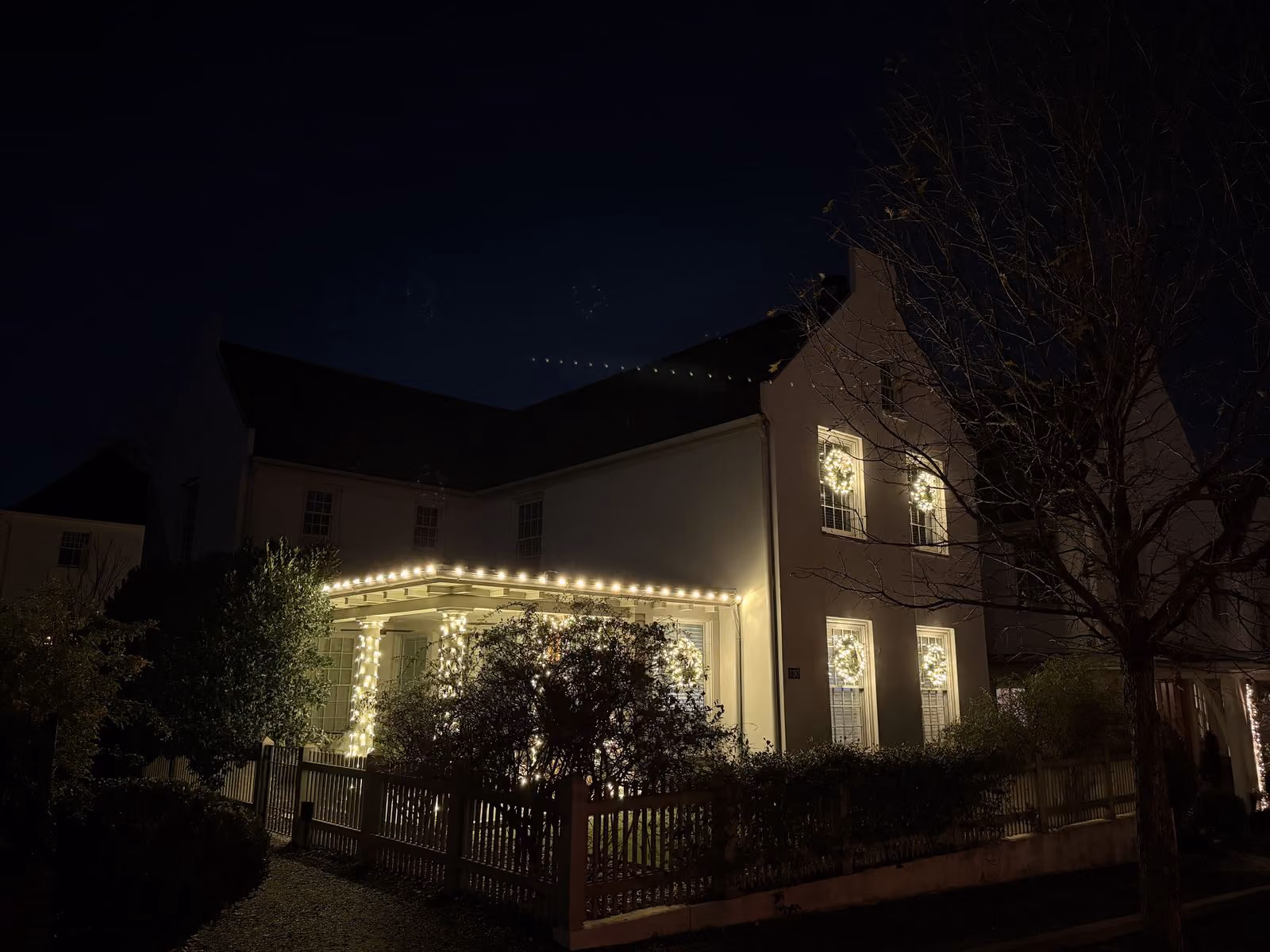 House decorated with Christmas lights at night.