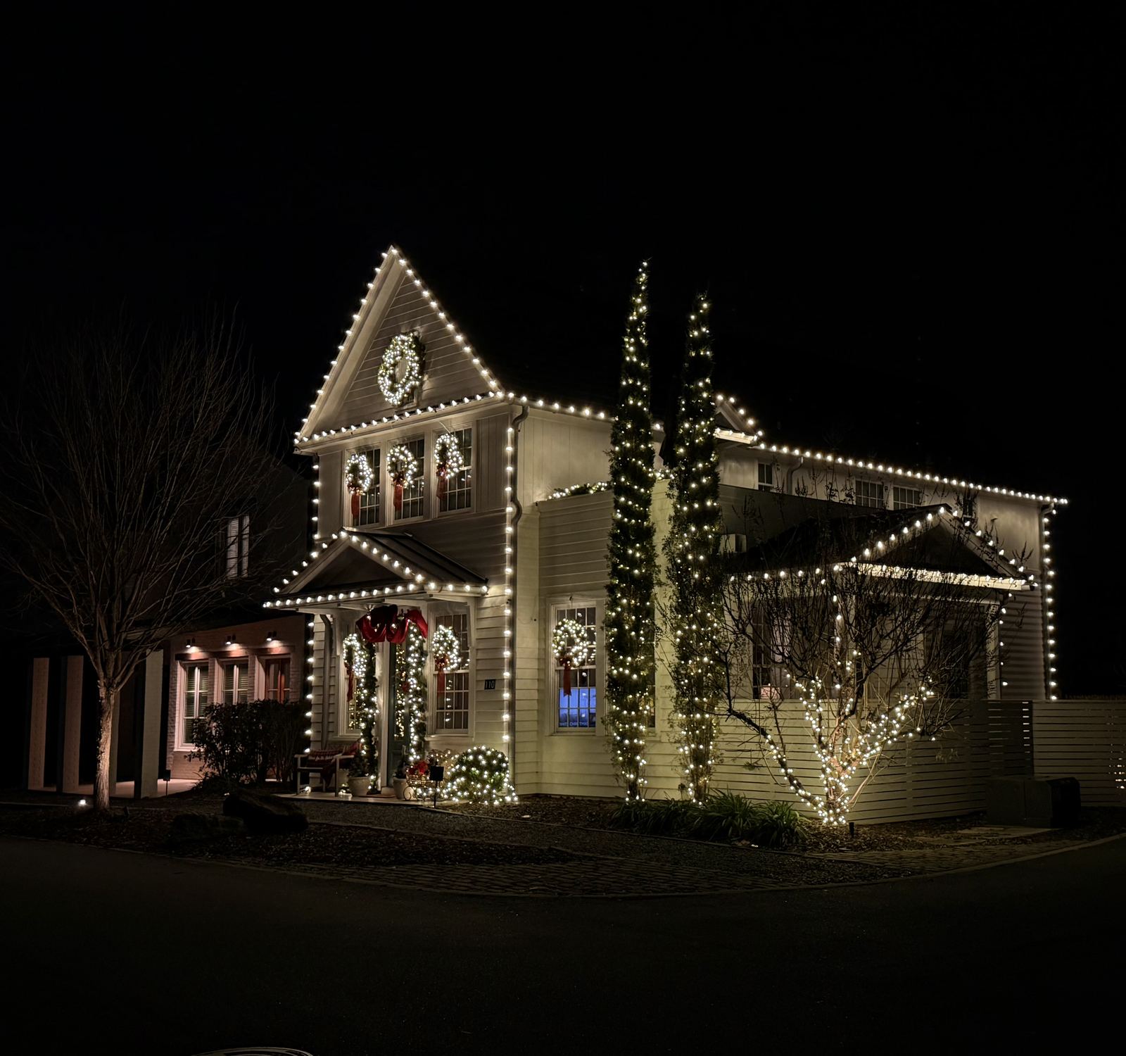 Multi-story South Metro Atlanta home with custom Christmas roofline lighting by Icy Lights