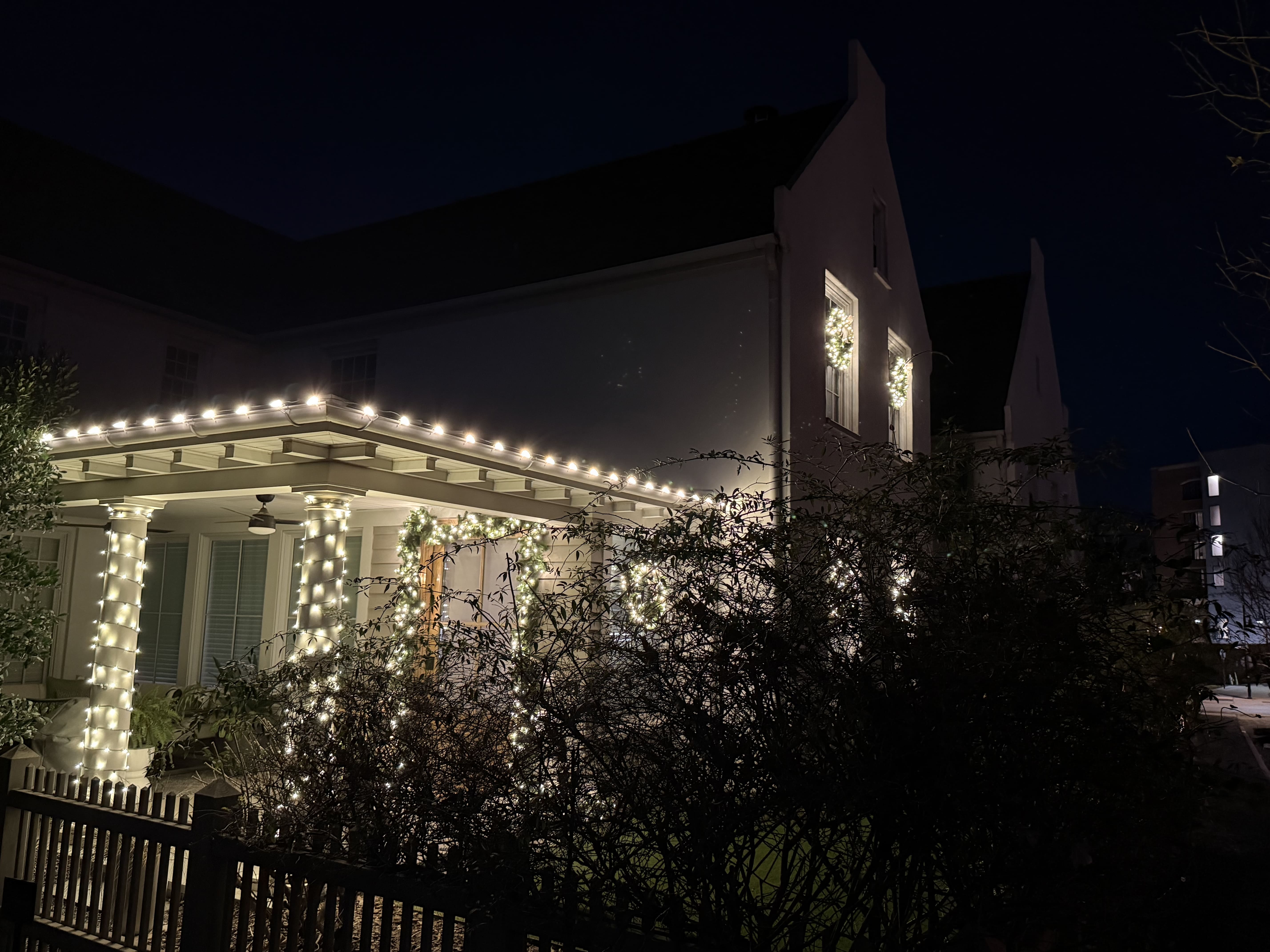 House decorated with Christmas lights at night.