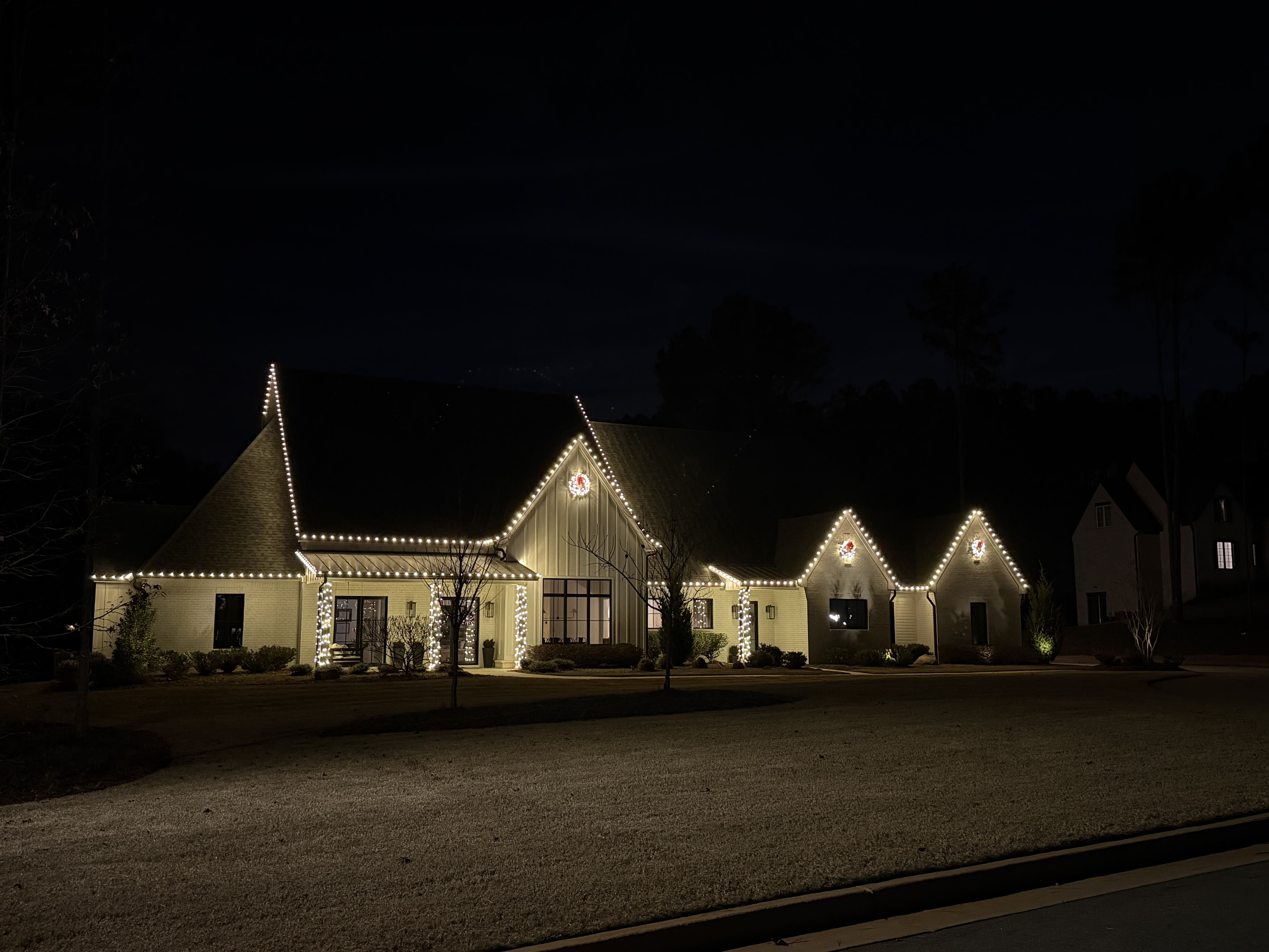House decorated with Christmas lights at night.
