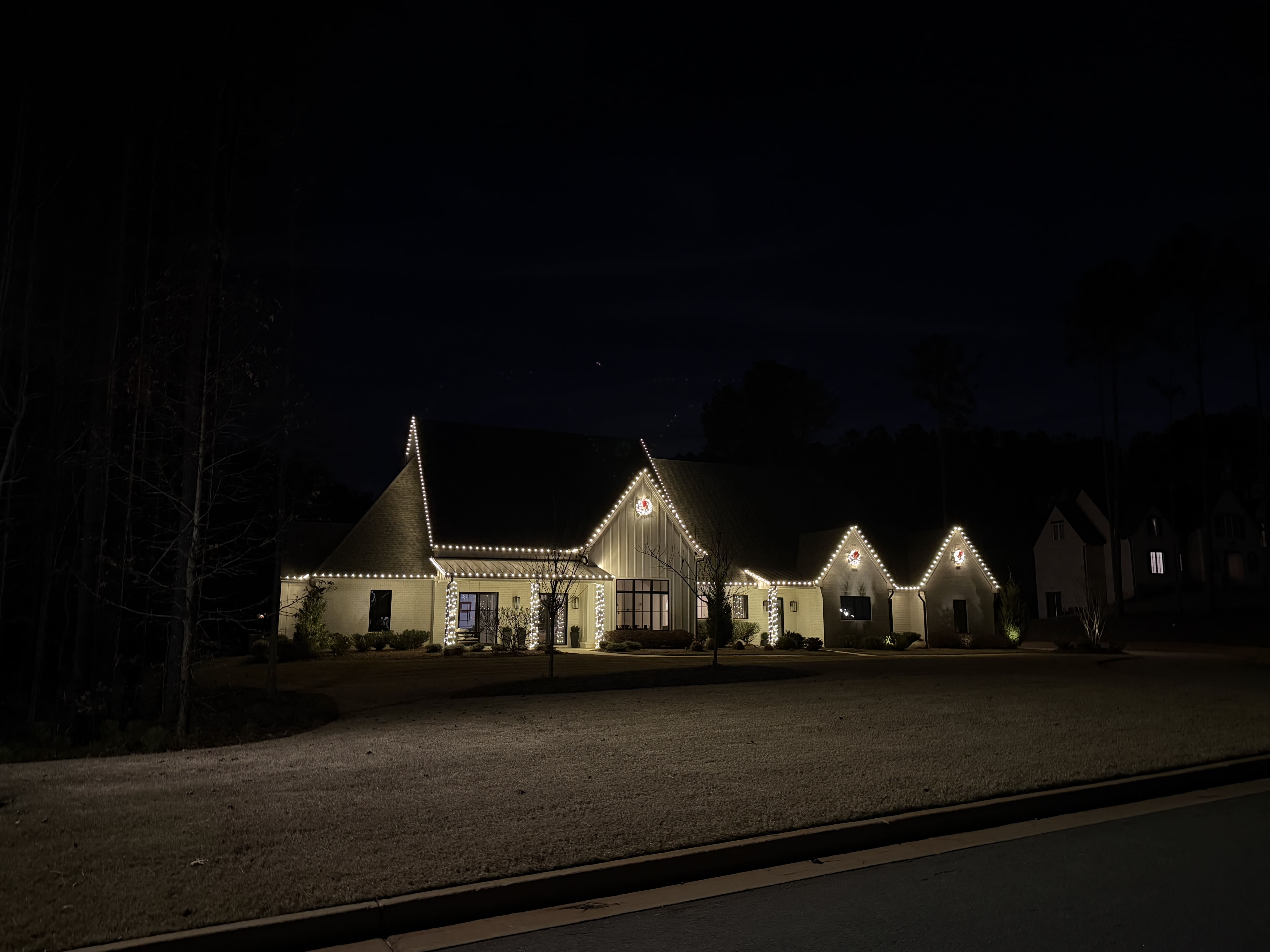 House decorated with Christmas lights at night.