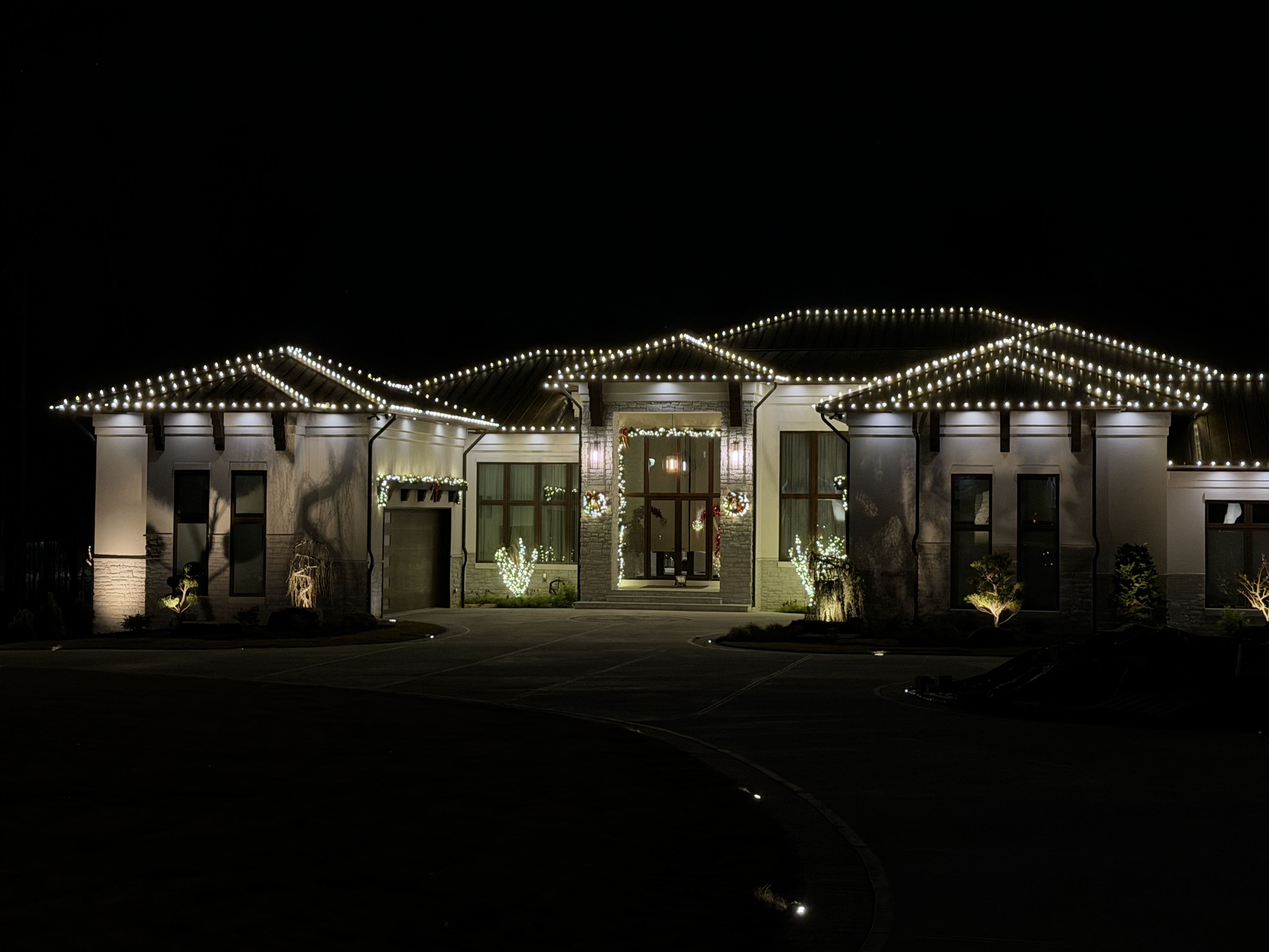 House decorated with Christmas lights at night.