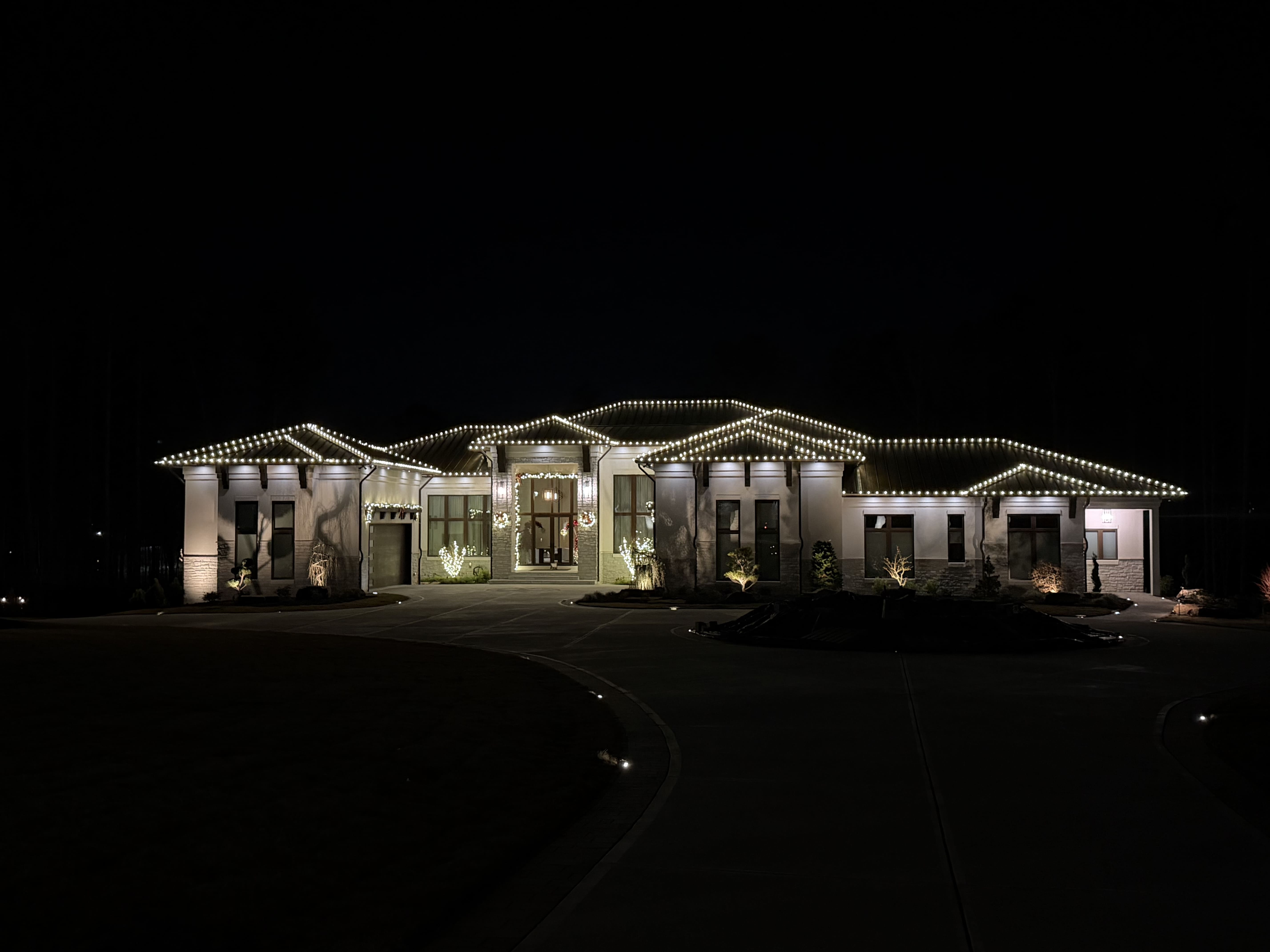 House decorated with Christmas lights at night.