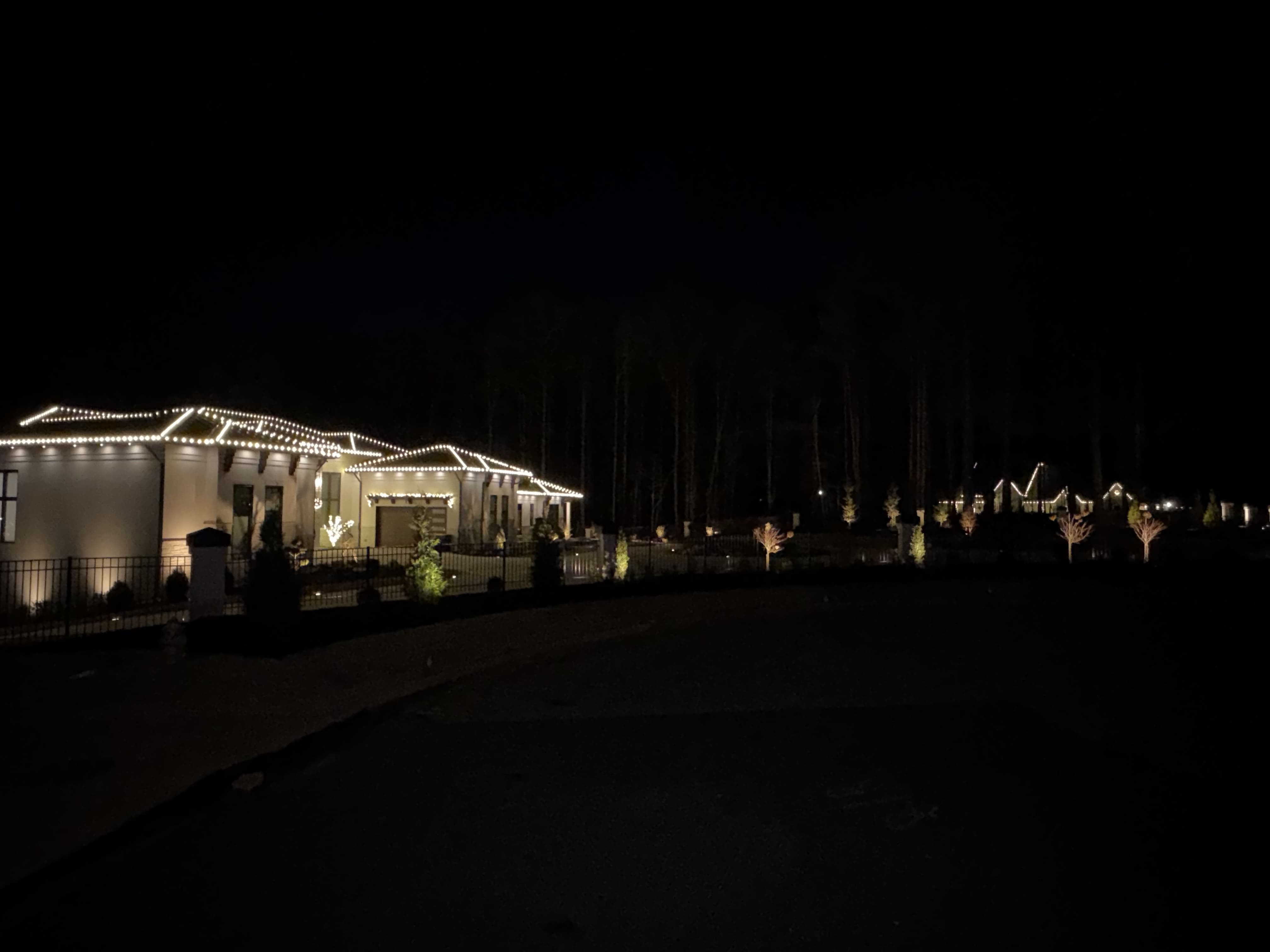 House decorated with Christmas lights at night.