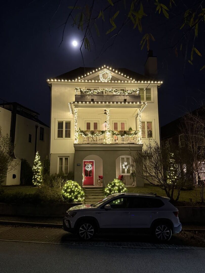 House decorated with Christmas lights at night.
